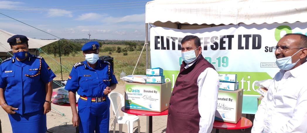Elite Offset Directors Harshit Shah and Pravin Pindoriya far right donating goods to police officers at the Athi River boarder point