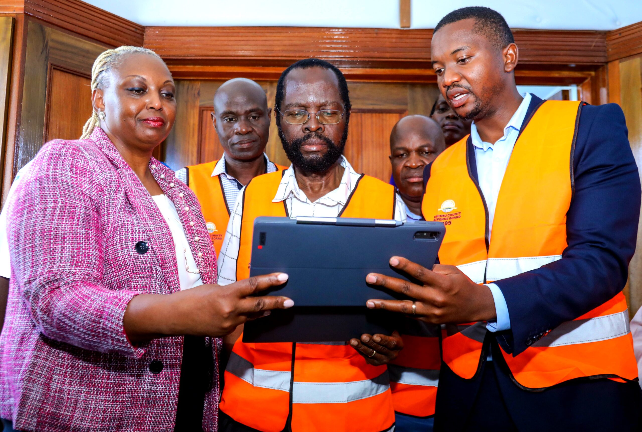Safaricom Plc, Chief Enterprise Business Officer, Cynthia Kropac (Left) and Safaricom Plc, Product Manager Enterprise Business Solutions, Isaac Kabutha (Right) explains to Kisumu County Governor, H.E. Prof. Peter Anyang’ Nyong’o how the integrated county revenue management system (ICRMS) works during the Safaricom launch in Kisumu.