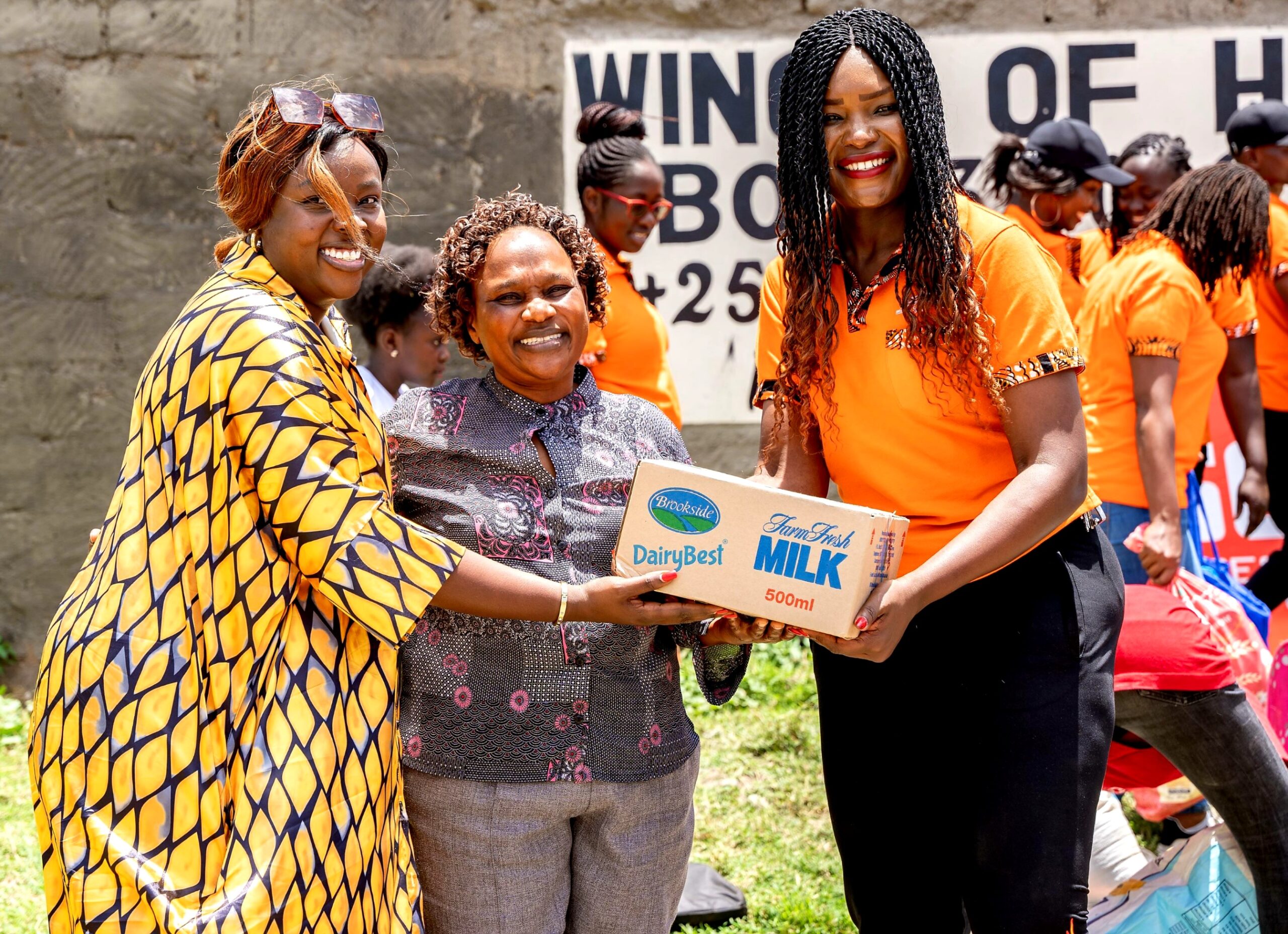 SGA Security Group PR and Branding Manager Josephine Wanjiru and Sales & Marketing Manager Irene Opondo give part of the donations to Wings of Hope Director Ms Fransisca Kiio during a visit to Wings of Hope Rescue Home as a celebration during International Women's Day.