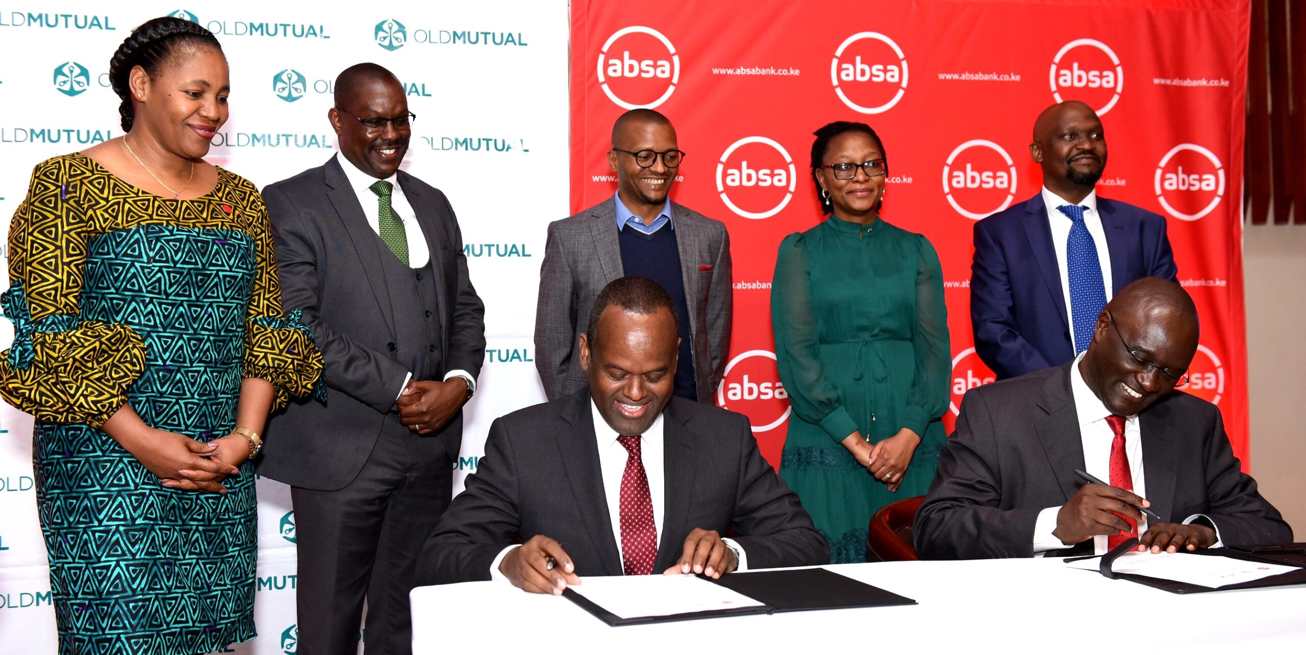 Absa Bank Kenya MD & CEO Abdi Mohamed and Old Mutual East Africa Group CEO Arthur Oginga sign an MoU signifying the launch of the Linda Biz SME bundled insurance solution that offers a comprehensive suite of insurance products including general, health and life insurance uniquely tailored to meet the specific needs of SMEs. Looking on are (L-R) Absa Bank Kenya Business Banking Director Elizabeth Wasunna, Old Mutual Investment Group, Group MD Anthony Mwithiga, Absa Bank Kenya Legal and Compliance Director Kenneth Kanyarati, Old Mutual Life Assurance Kenya MD Loreen Makwanya and Old Mutual General Insurance Kenya MD Japheth Ogalloh.  