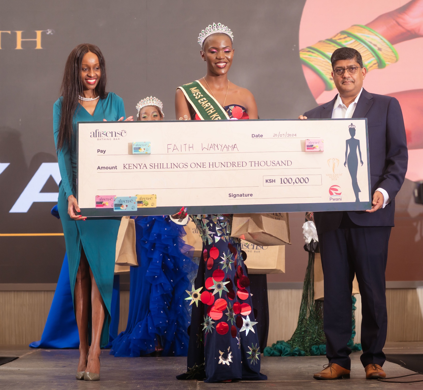 Pwani Oil's Head of Marketing, Caroline Ntinyari (L), and Pwani Oil's Commercial Director, Rajul Malde (R), present a KES 100,000 cheque to Miss Earth Kenya 2024, Faith Wanyama, during the pageant gala at the Argyle Grand Hotel in Nairobi. In addition to the cash prize, and a three-month internship with Pwani Oil Products Limited, Ms. Wanyama is now an ambassador of the Afrisense Luxury Bathing Soap. PHOTO/COURTESY