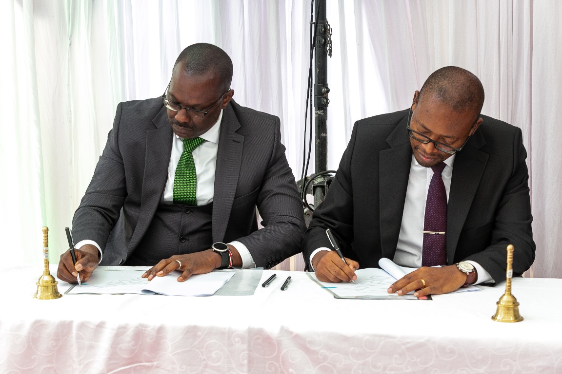 (L-R) Old Mutual Investment Group (OMIG) Managing Director, Anthony Mwithiga, and Faulu Microfinance Bank CEO, Julius Ouma, sign a partnership agreement during the launch of the Faulu Bank Money Market Fund (MMF) in Nairobi.  The fund, which will be managed by OMIG, will allow Faulu's customers to invest in short-term financial instruments, earning competitive returns.