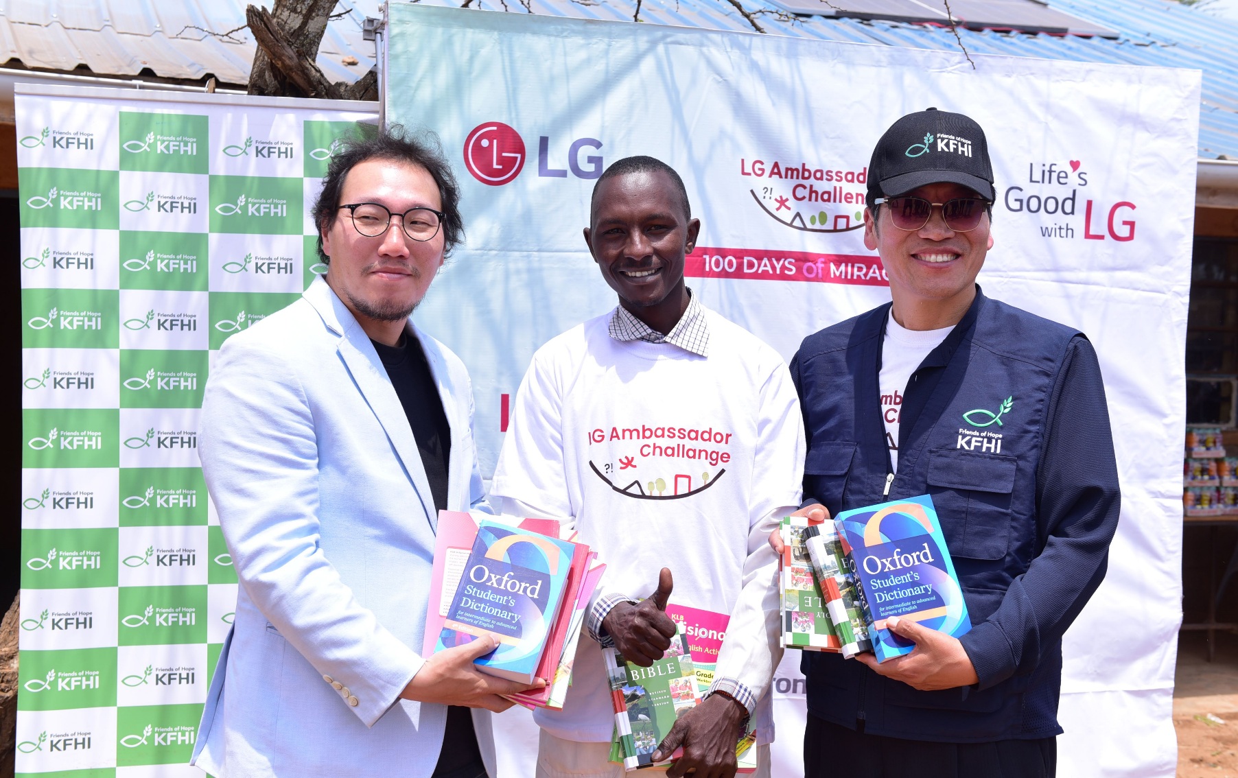 (L-R) LG Electronics EA Marketing Manager Changhyun Kim, Intinyika Primary School Acting Headteacher James Keshoe Letayian, and Korea Food for the Hungry International (KFHI) Director Chun Jong Hu pose with books donated to the school by LG and KFHI. The school, located in Oloililai Subcounty, received various equipment, including solar systems, water tanks and computers, to address its critical infrastructure needs. PHOTO/COURTESY