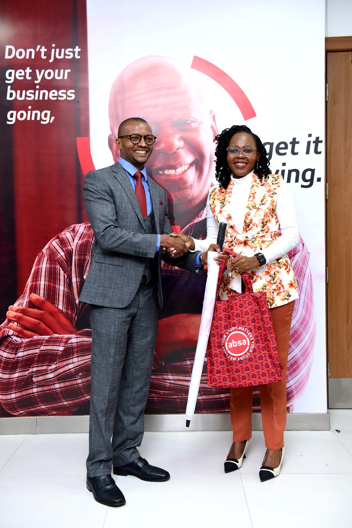 Absa Bank Kenya Legal and Compliance Director Ken Kanyarati with Penzi Hospital Finance and Administration Director and Absa Customer Agnes Njeri during the Kamakis Branch Opening.