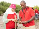 Absa Bank Kenya's Chief Finance Officer Yusuf Omari and Coast Regional Manager Fathiya Noordean during a coastal restoration programme at the Sabaki Estuary in Malindi.