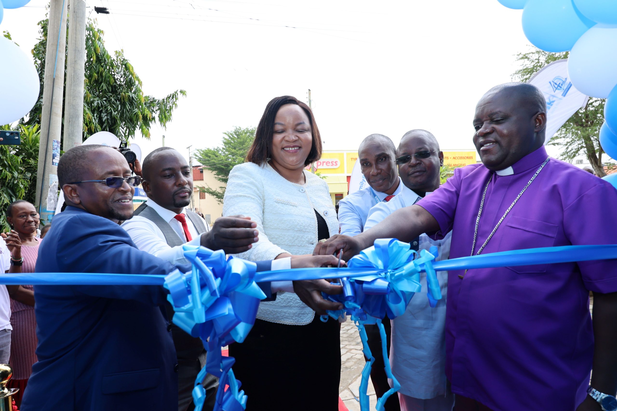 Family Bank CEO Nancy Njau (C), Chief Commercial Officer John Ndugi (L), & Coast Area Manager Timothy Muchiri during the official opening of the 96th branch in Kilifi. Looking on is Kilifi Branch Manager Peter Ndzai, Rev. Benson Jumbale, and Rev. Bishop Reuben Shukuru Katite of ACK Diocese of Malindi.